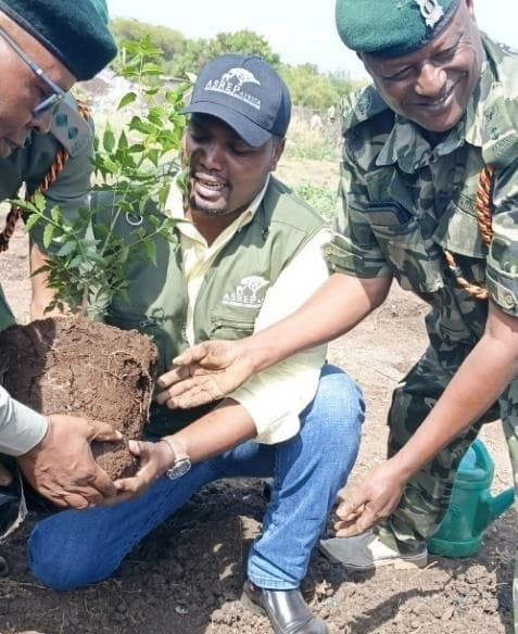 A forestry officer supervising rangers during an ASREP-coordinated tree planting exercise in Isiolo County